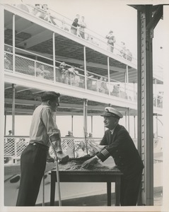 Captain Frank Brown shows model ship to Robert Wright