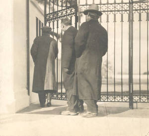 Herbert L. Pratt and two others walking through the gate to Pratt Field (1910)