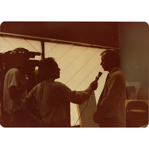 Reporter and cameraman interviewing Jorge Hernandez.