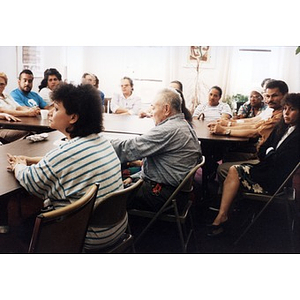 Men and women gathered together for a meeting in the Inquilinos Boricuas en Acción offices.