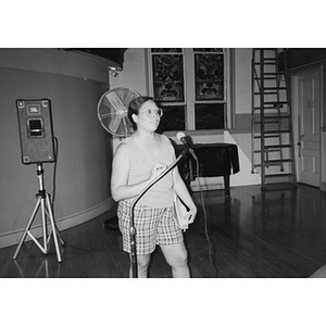 Woman at the microphone during a community meeting.