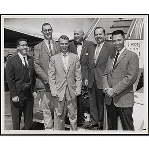 Group portrait of six men in front of an airplane, including Paul F. Hellmuth and Arthur T. Burger, standing second and third from right