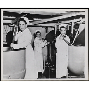Three members of the Tom Pappas Chefs' Club stir vats aboard the USS Salem