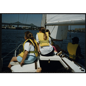 Two girls gaze at Boston Harbor from a sailboat