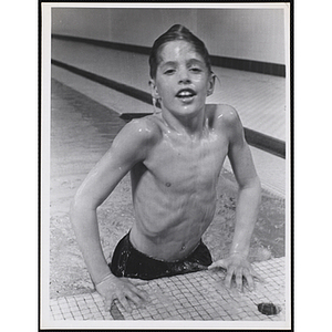 A boy emerges form a natatorium pool