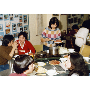 Guests eating at a Chinese Progressive Association party