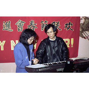 Man and woman chat beside a keyboard during a celebration of the Chinese New Year