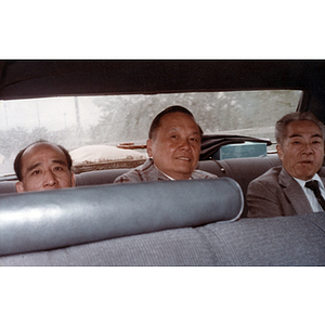 You King Yee and two other male members of the Chinese Progressive Association sit on the backseat of a car before meeting Chinese Ambassador Chai Zemin during his visit to Boston