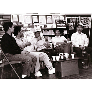 Five Lei Jing Restaurant construction workers drink coffee at the Chinese Progressive Association headquarters