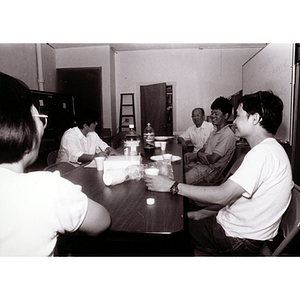 Three Lei Jing Restaurant construction workers have a meeting with two women