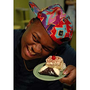 Ulysses Ifill poses with a dessert at the Torch Scholars visit to the Exhibition Kitchen