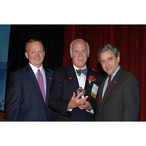 William Fowler poses with President Freeland and unknown speaker at the Alumni Ball