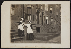 Three unidentified maids standing in front of a building in the South End, Boston, Mass., undated