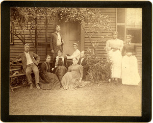Group portrait of a family and two women domestics in front of a dwelling, Chocorua, N.H., 1890
