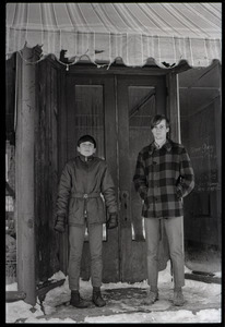 Millers Falls: two young men standing in the entryway to a shuttered shop