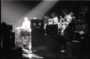 Santana concert at the Springfield Civic Center: view of band and audience from behind bank of audio equipment