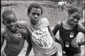 Three African American (possibly at summer camp), one wearing a Spirit in Flesh t-shirt