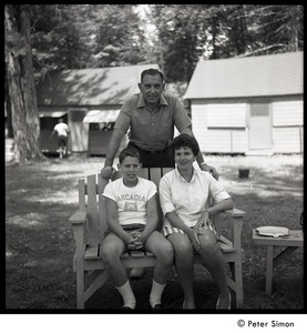 Camp Arcadia: camper seated with his parents