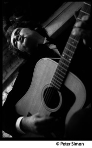 Tim Hardin playing guitar and smoking at the Unicorn Coffee House, Boston, Mass.