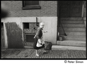 Older woman walking along the street, Beacon Hill