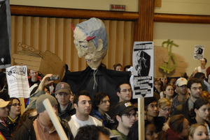 UMass student strike: strikers in the Student Union ballroom holding signs supporting a general student strike and a paper machie puppet