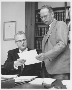 John W. Lederle and Lamar Soutter examining a paper