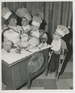 Connie Boswell dressing Thanksgiving turkey with young clients