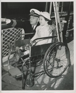 Child in wheelchair shown sights by captain