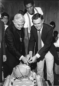 Mayor Raymond L. Flynn , Archbishop Bernard F. Law and Boston Celtics player Robert Parish cutting a basketball cake