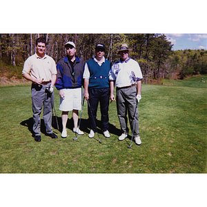 A four-man golf team posing with their clubs at the Charlestown Boys & Girls Club Annual Golf Tournament