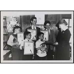 "Mrs. Frank Mansfield Taylor, member of the Library Committee, presenting Junior Book Award certificates at the Bunker Hill Clubhouse Library, April 6, 1956"