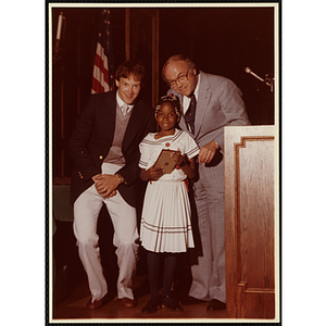 Sherie Craft receives an award from Robert Cleary, Overseer of the Boys' Clubs of Boston, at right, and an unidentified man