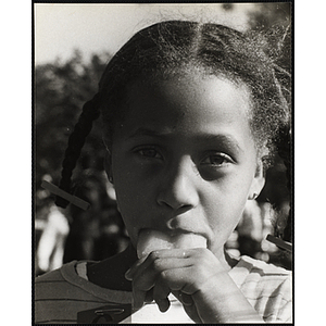 Close-up of an African American girl from the Roxbury Boys' Club sticking her tongue out