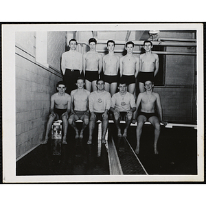 Teenage boys pose for a team shot with thier swim coach