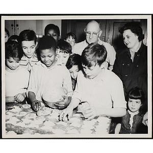 Members of the Tom Pappas Chefs' Club prepare baked goods in a kitchen