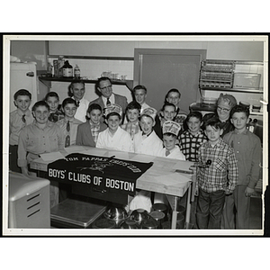 Members of the Tom Pappas Chefs' Club pose for a group shot in a kitchen with two men and woman