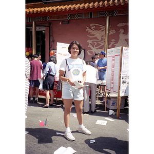 Woman distributes fliers at the August Moon Festival