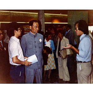 Mr. Wong, a Youxie delegate from the U.S.-China Peoples Friendship Association, talks to two men on a visit to the Josiah Quincy School