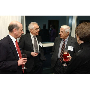 Gerald Betro, George Makris and two unidentified people converse at The National Council Dinner