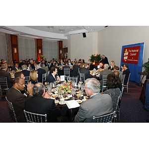 Seated guests applaud for a speaker at The National Council Dinner