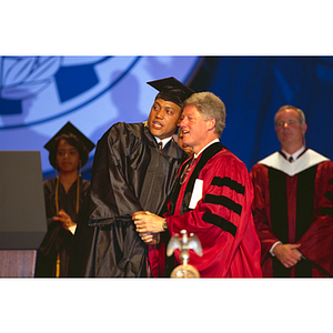 President Clinton, right, shaking hands with a student at commencement