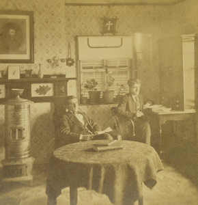 Stereograph of two men sitting in a room, location unknown, undated