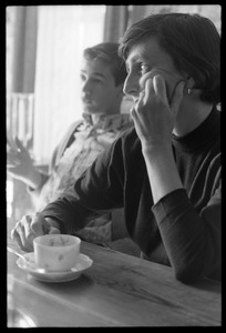 Solange 'Nellie' Hertz and son seated at a table at home with a cup of coffee