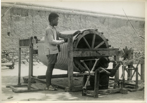 Chinese boy and girl working with loom