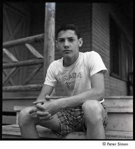 Camp Arcadia: portrait of a camper seated on cabin steps