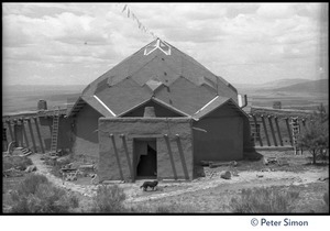 The dome at the Lama Foundation: close-up of entrance with dog outside