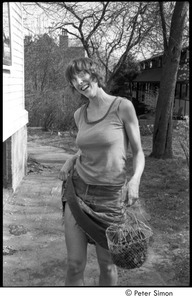 Ram Dass retreat at David McClelland's: woman holding a basket and lifting the side of her skirt