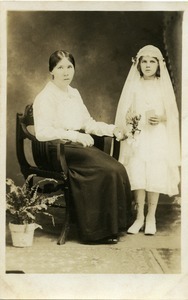 Mother and daughter, Eleanora Sek, at first communion, possibly Easthampton, Mass: full-length studio portrait of mother seated next to daughter