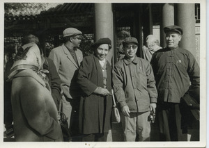 Shirley Graham Du Bois standing with Robert F. Williams and unidentified Chinese workers