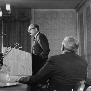 Robert C. Wood standing at a podium